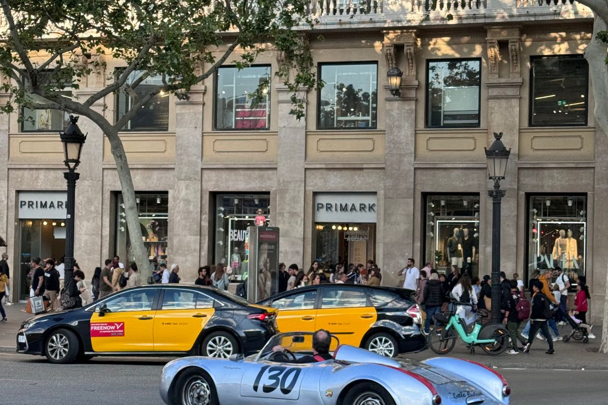 Black-and-yellow Barcelona taxis on a city avenue